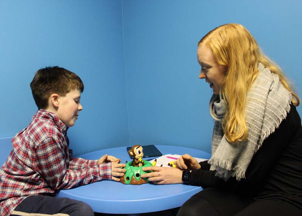 Kayla SLP working witha child